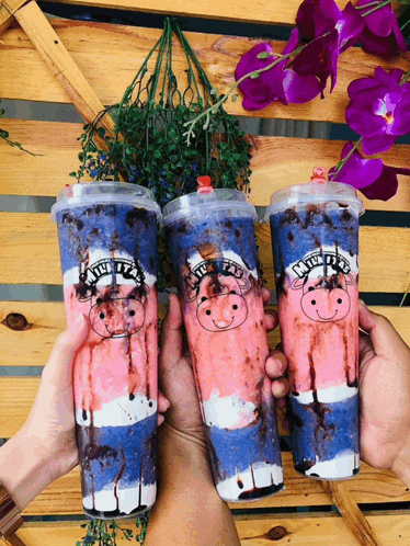 three milk tea cups with pigs on them