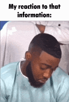 a man with a beard is looking down with the words my reaction to that information below him .