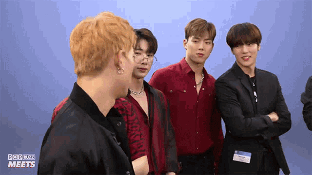 a group of young men standing next to each other with pop buzz meets written on the bottom right