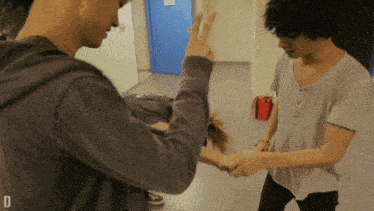 a man giving a peace sign while another man holds a woman 's hand