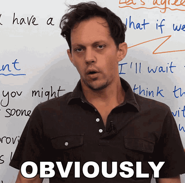 a man stands in front of a white board with the words obviously on it