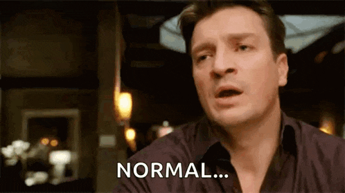 a man in a black shirt is making a funny face and says `` normal '' .