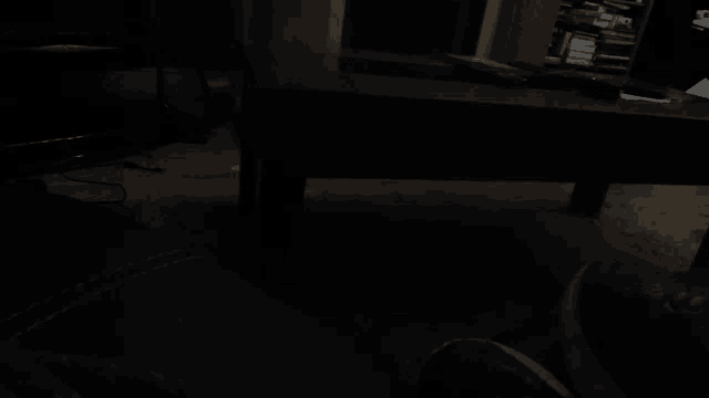 a dark room with a couch and a table