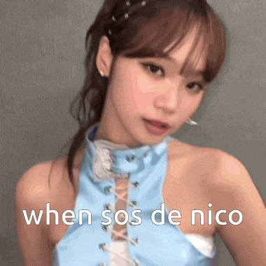 a woman in a blue top with the words `` when sos de nico '' written on the bottom .
