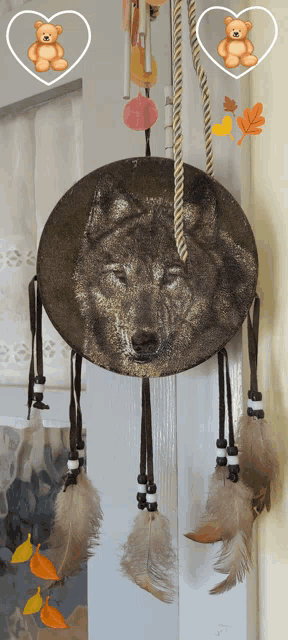 a dream catcher with feathers and a picture of a wolf