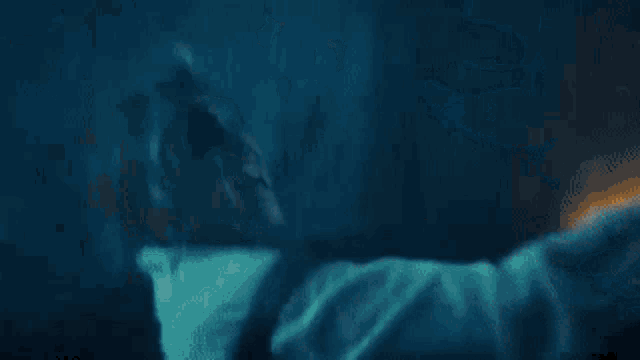 a close up of a person 's back in the dark with smoke coming out of it .