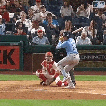 a baseball player with the number 2 on his back is about to swing at a pitch