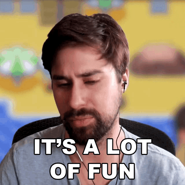 a man with a beard and ear buds says it 's a lot of fun