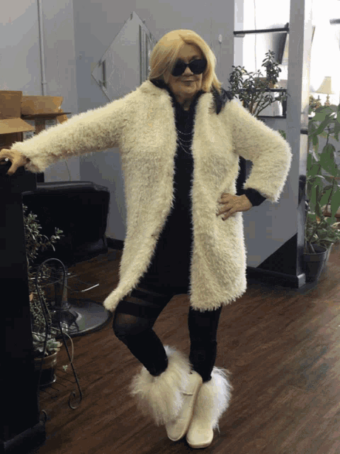 a woman wearing sunglasses and a fur coat