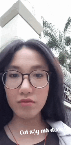 a woman wearing glasses and headphones has a caption that says coi zậy ma duoc