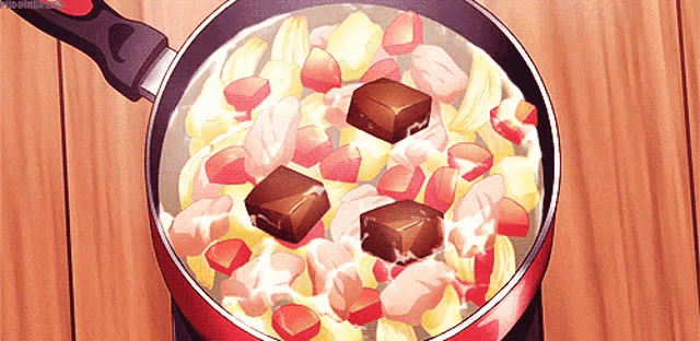 a pan filled with food and chocolate cubes on top of it .