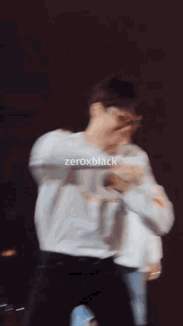 a man wearing sunglasses and a white shirt has zeroxblack written on the bottom