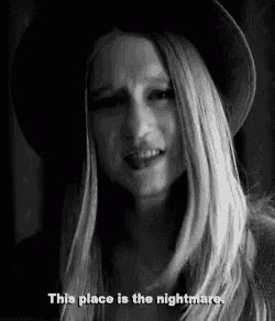 a woman wearing a hat is crying in a black and white photo and says `` this place is the nightmare '' .
