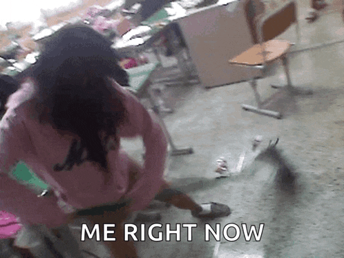 a girl in a pink shirt is standing in a classroom with the words " me right now " written on the floor