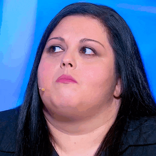 a woman with a microphone in her mouth looks up