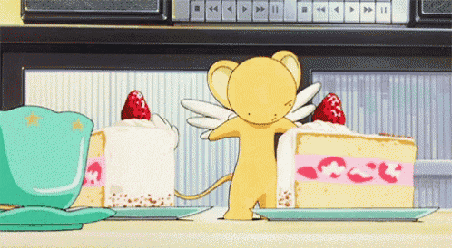 a cartoon character is standing in front of two slices of cake with strawberries on them .