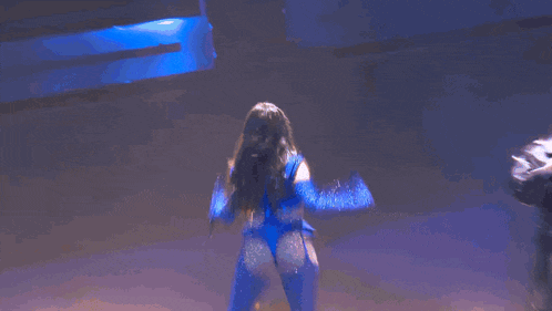 a woman in a blue outfit is dancing on a blue background