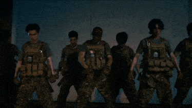 a group of men in military uniforms are dancing