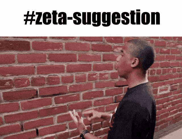 a man standing in front of a red brick wall with the hashtag #zeta-suggestion