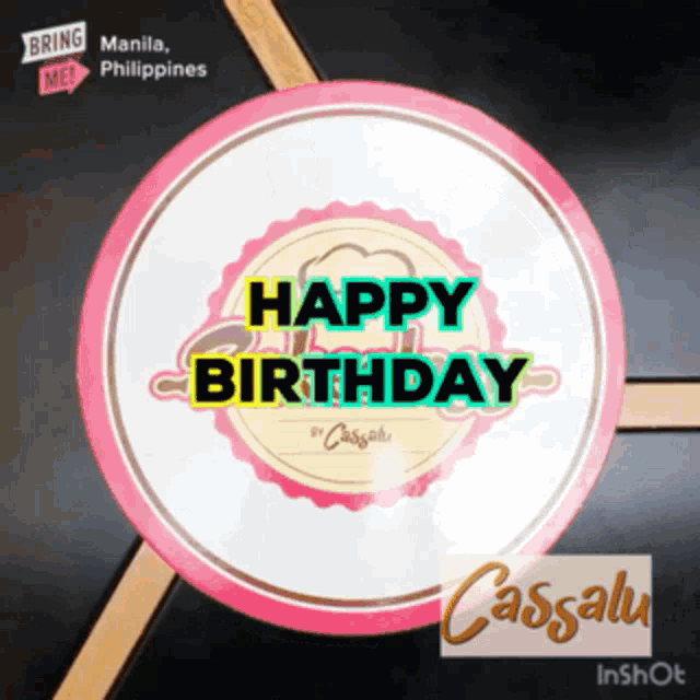 a pink and white circle with the words happy birthday on it