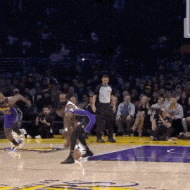 a couple of basketball players are playing basketball on a court .