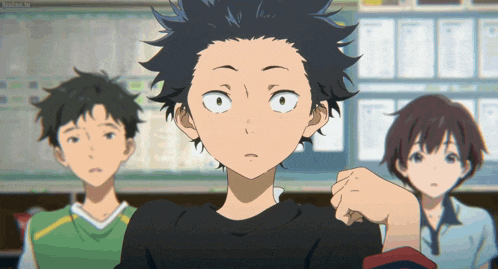 a boy in a black shirt stands in front of a group of people