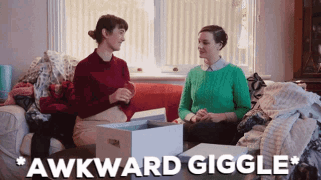 two women are sitting on a couch with the words " awkward giggle " written above them