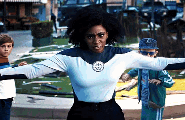 a woman in a superhero costume is standing on a street .