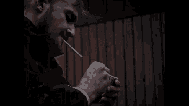 a man lighting a cigarette with a lighter
