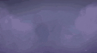 a girl with blue hair is standing in a dark room in a video game .