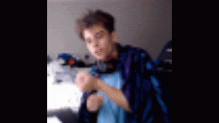 a blurry picture of a young man wearing headphones .