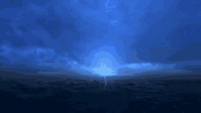 a lightning bolt strikes in the middle of a stormy ocean