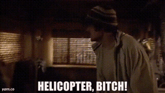a man is laying on a bed with a blanket and a helicopter , bitch !