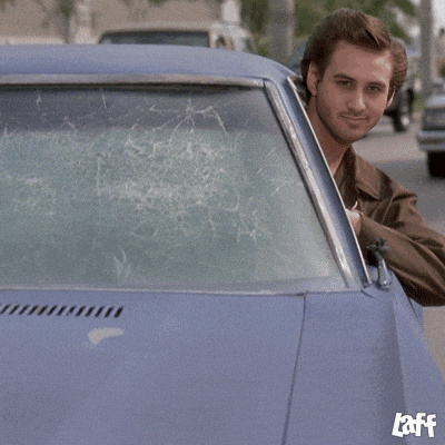 a man in a car with the word laff on the bottom left