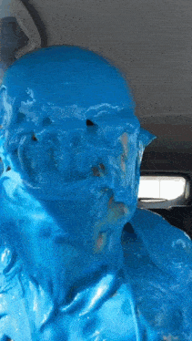 a person with their face covered in blue liquid