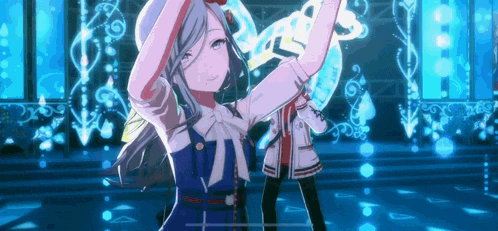 a girl in a blue dress is dancing on a stage with a man in a white jacket .
