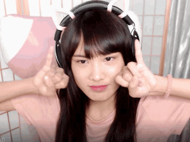 a girl wearing headphones with cat ears on it