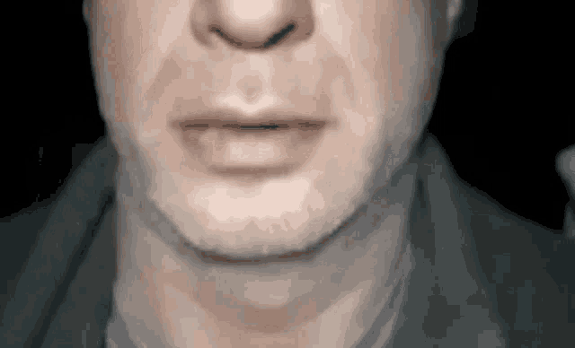 a close up of a man 's mouth and neck