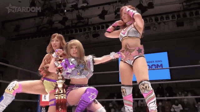 three women are in a wrestling ring with the word stardom on the bottom right