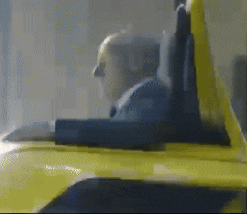 a blurred image of a person sitting in a yellow chair