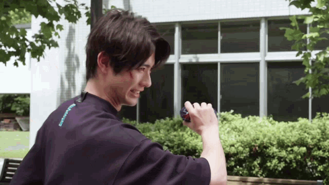 a man wearing a black shirt with the word tokyo on it