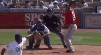 a baseball player is getting ready to hit a ball while a catcher and umpire look on .