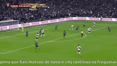 a soccer game is being played on a field with toyota banners on the sidelines