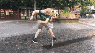 a person wearing a shirt that says ' brooklyn ' on it is standing on a cobblestone street