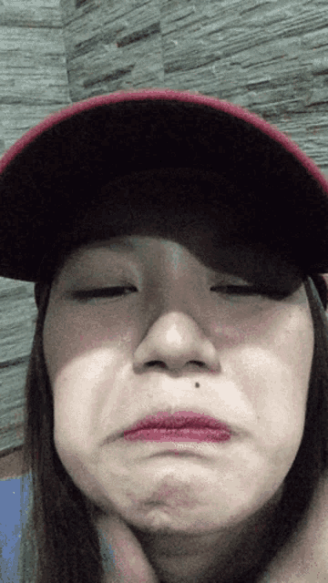 a woman wearing a red hat with the word columbia on it