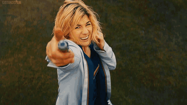 a woman in a white coat is holding a light in her hand