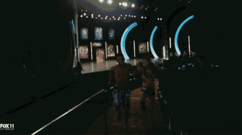 a man and a woman are dancing in front of a fox 11 advertisement