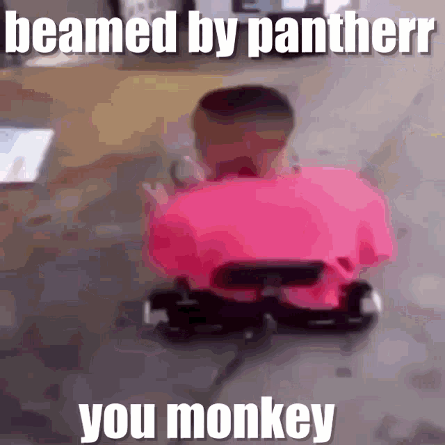 a man in a pink shirt is riding a go kart with the caption beamed by pantherr you monkey .