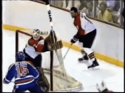 a hockey player with the number 15 on his jersey stands on the ice