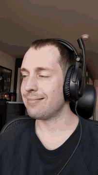 a man wearing a pair of black headphones with a microphone on his head